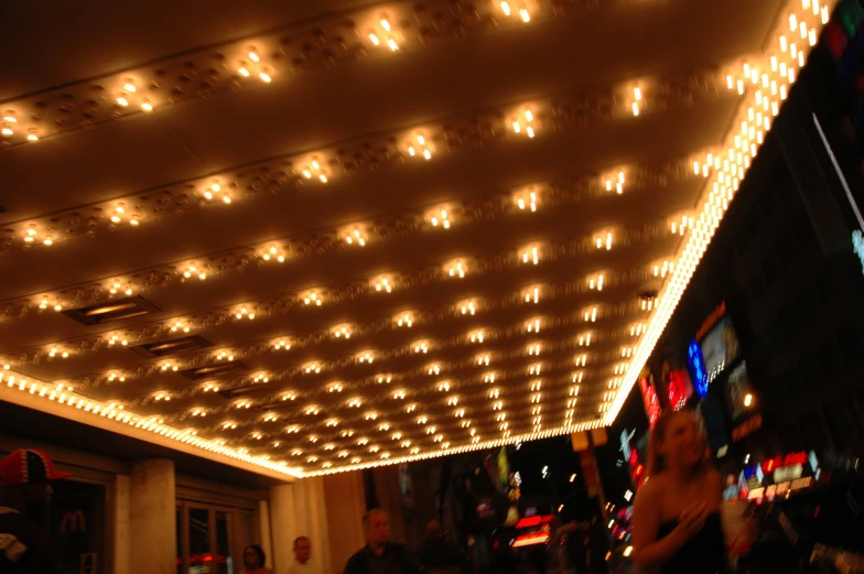 a lighted ceiling with people in the distance