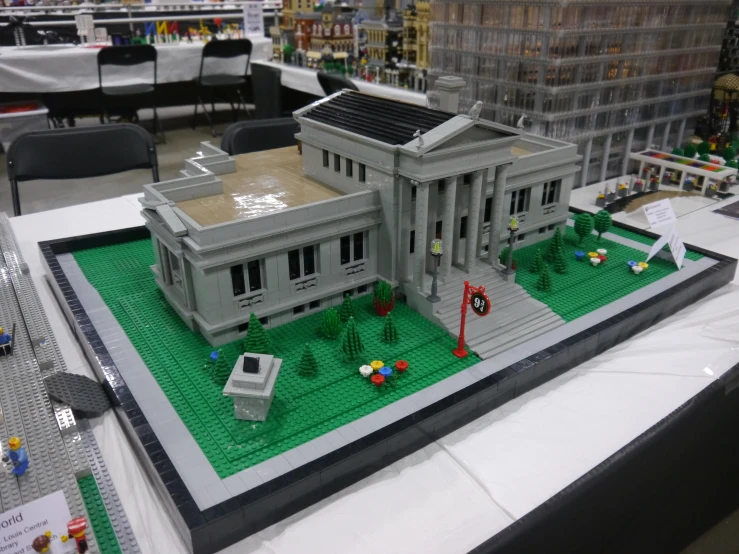 a large model of the white house in front of several small trees