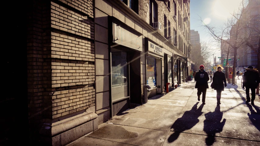 a group of people walking down a city street