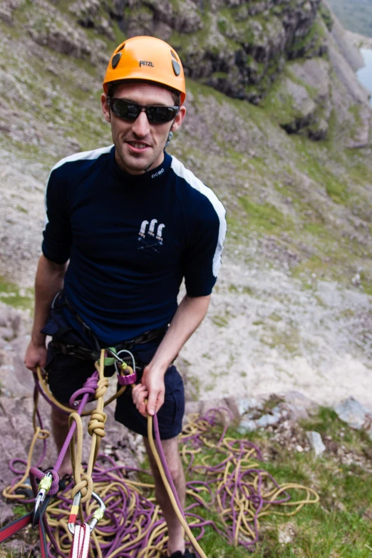 a man holding a rope and wearing a helmet