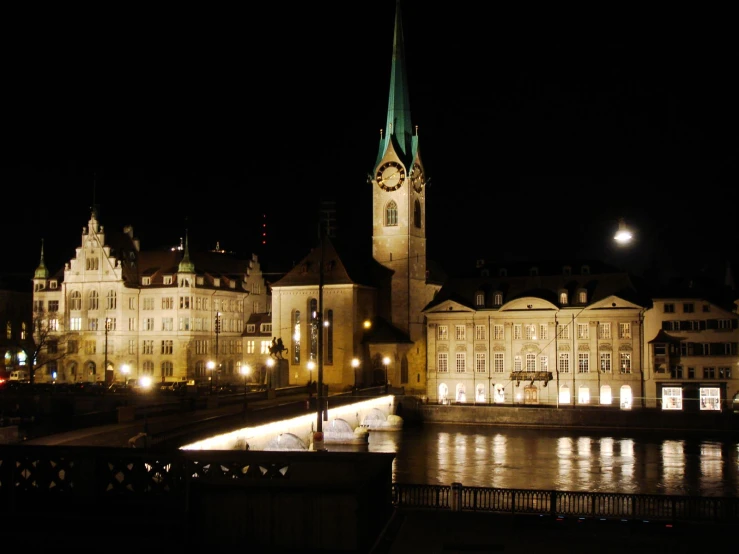 a view of the old buildings and river at night