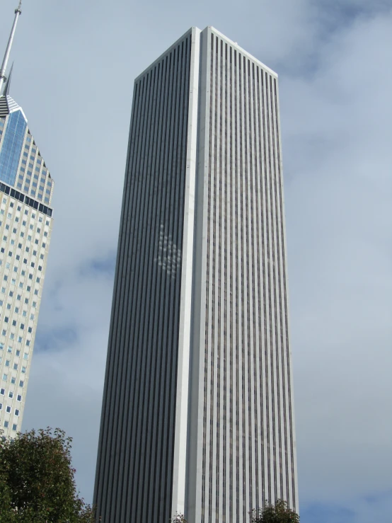 tall buildings are pictured against a cloudy sky