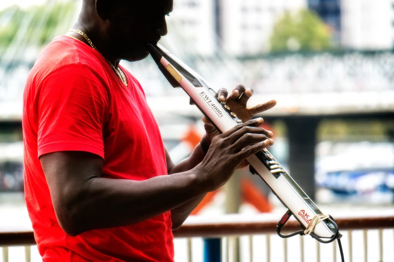 a man in red shirt playing an instrument