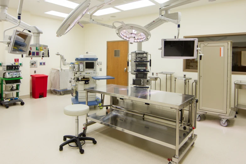 a hospital room with a table and medical equipment in it