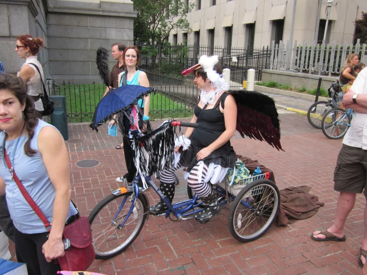 two women on a bike with an angel on it