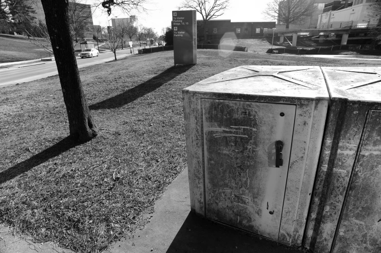 a black and white po of a wooden box on the sidewalk