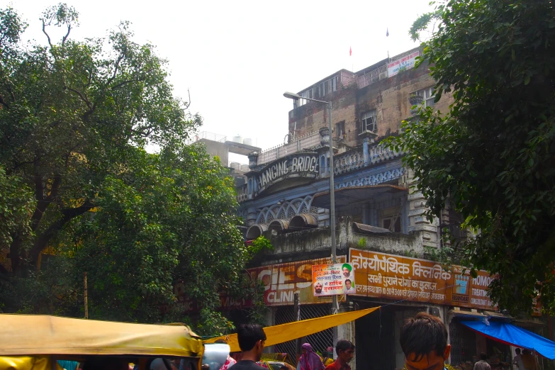 there are people walking outside an old, run down building