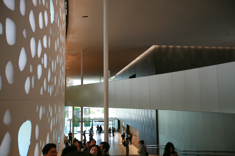 there is a crowd of people walking through a building