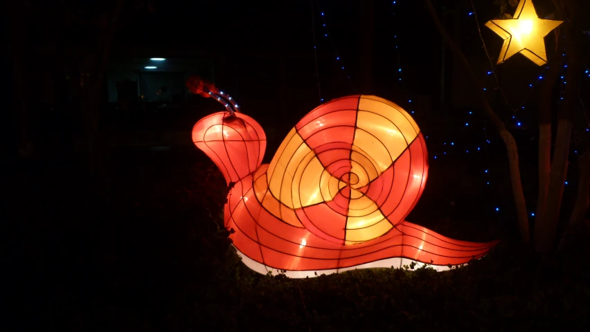 colorful lamps sitting on a lawn at night