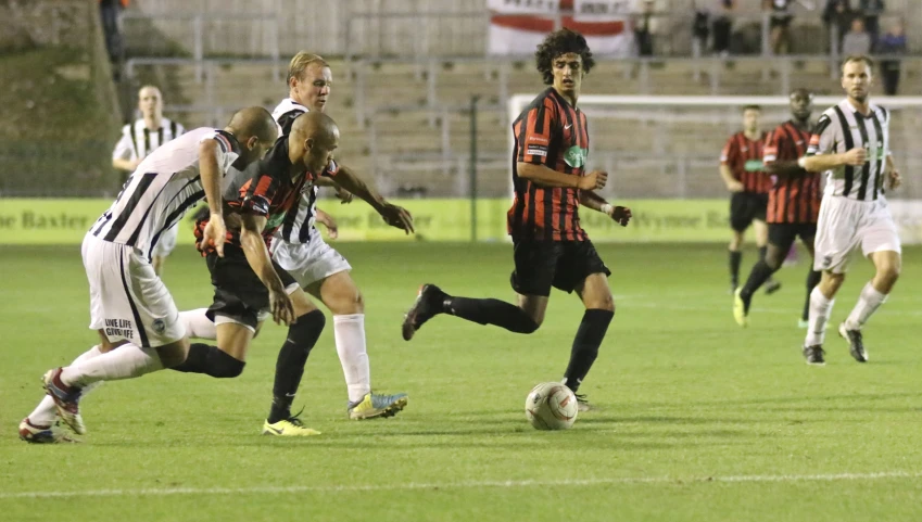 several men playing soccer on a soccer field