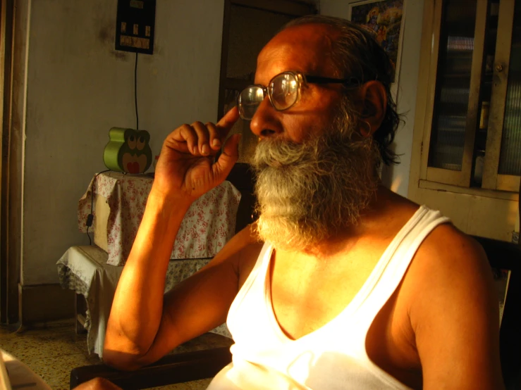 a man wearing glasses while smoking a cigarette