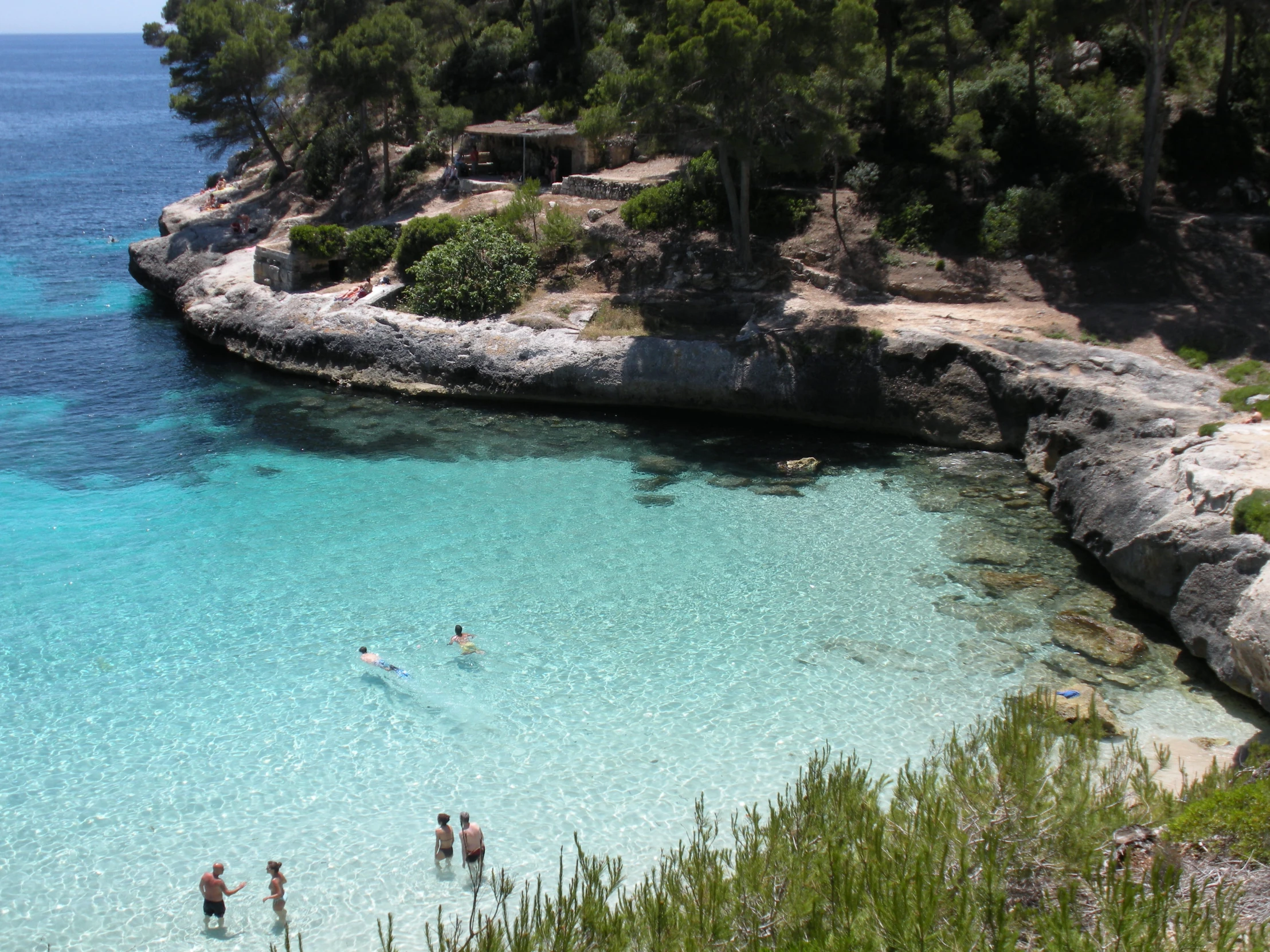 people are in the crystal blue water of a lagoon