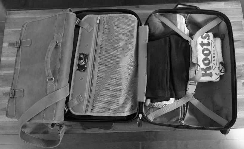 a closeup of a suit case with different items inside