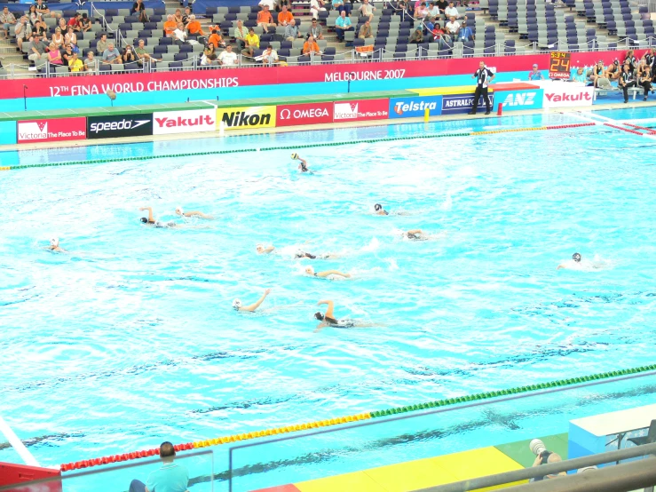 people in an empty swimming pool watching spectators