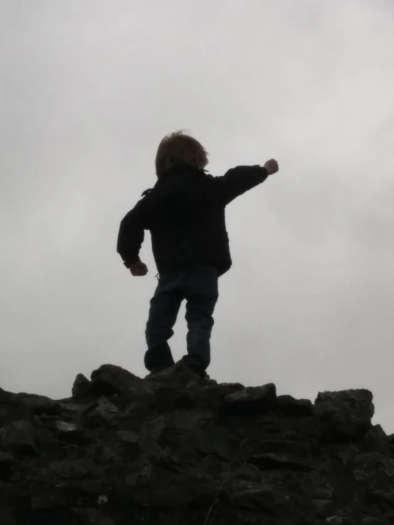 a person standing on top of a pile of rocks