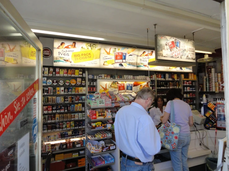 two people are standing outside a store with food