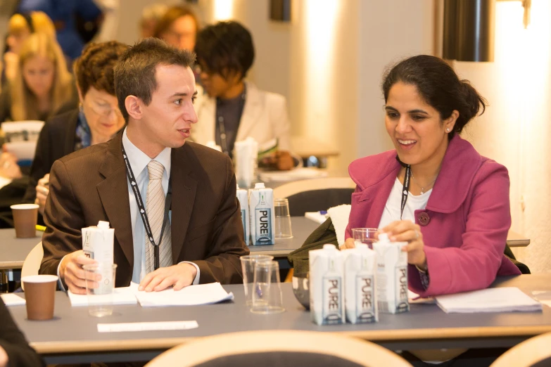 a man and woman sitting at a table talking