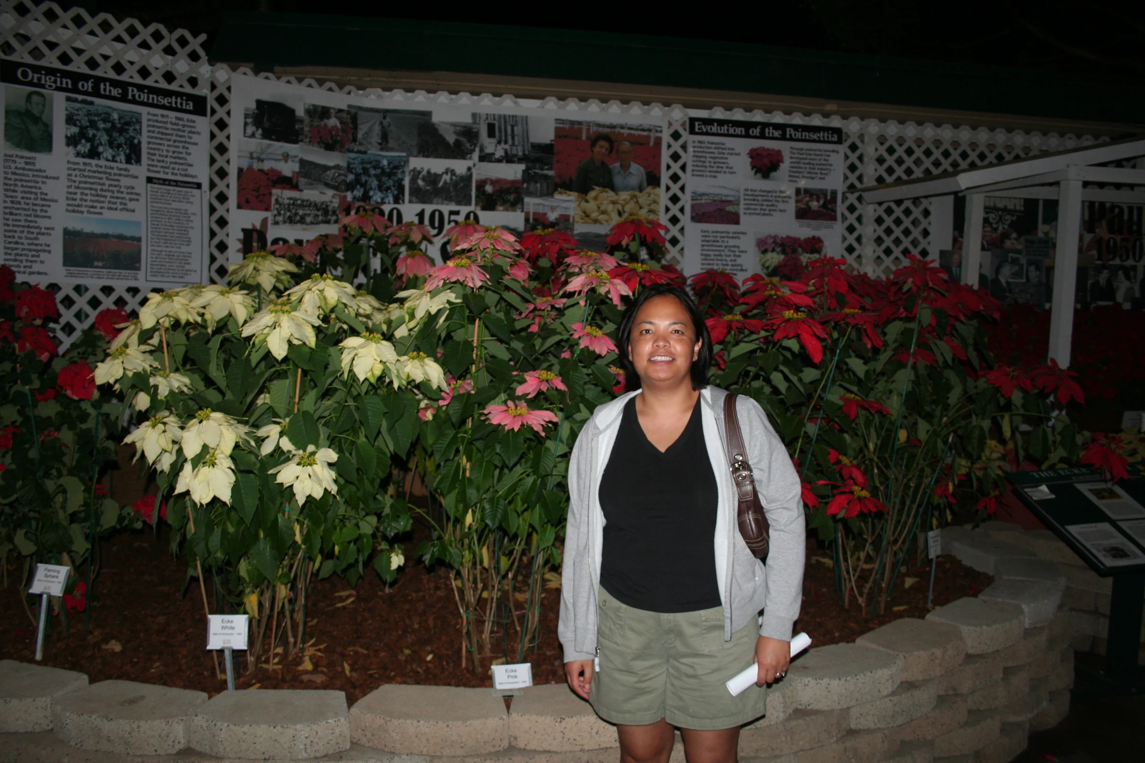 a woman smiling with flowers in the background