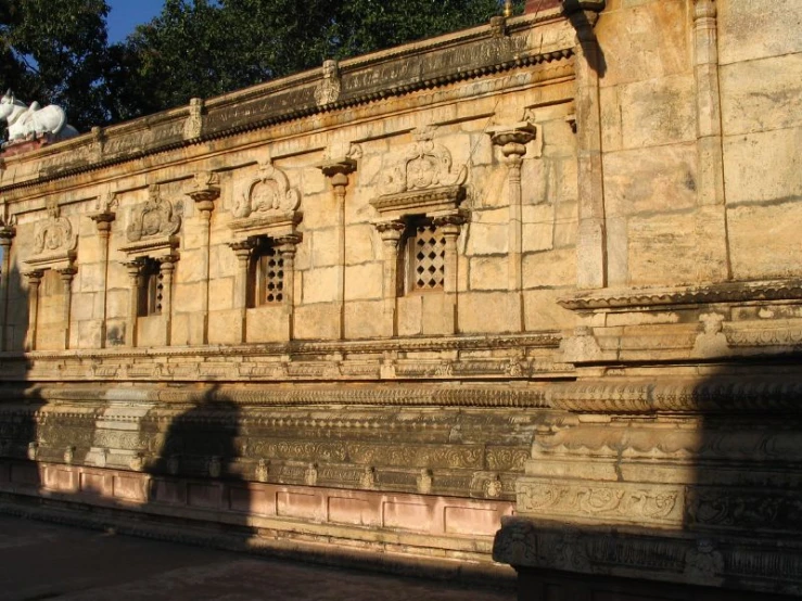 the shadow of an old building with carved windows