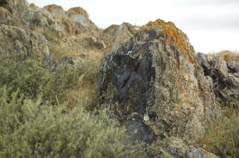 a single rock in the middle of some rocks