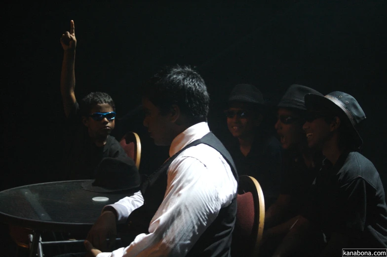 several men at a table in the dark