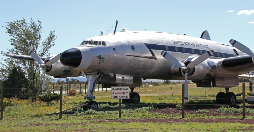 an airplane sitting on display on a grass field