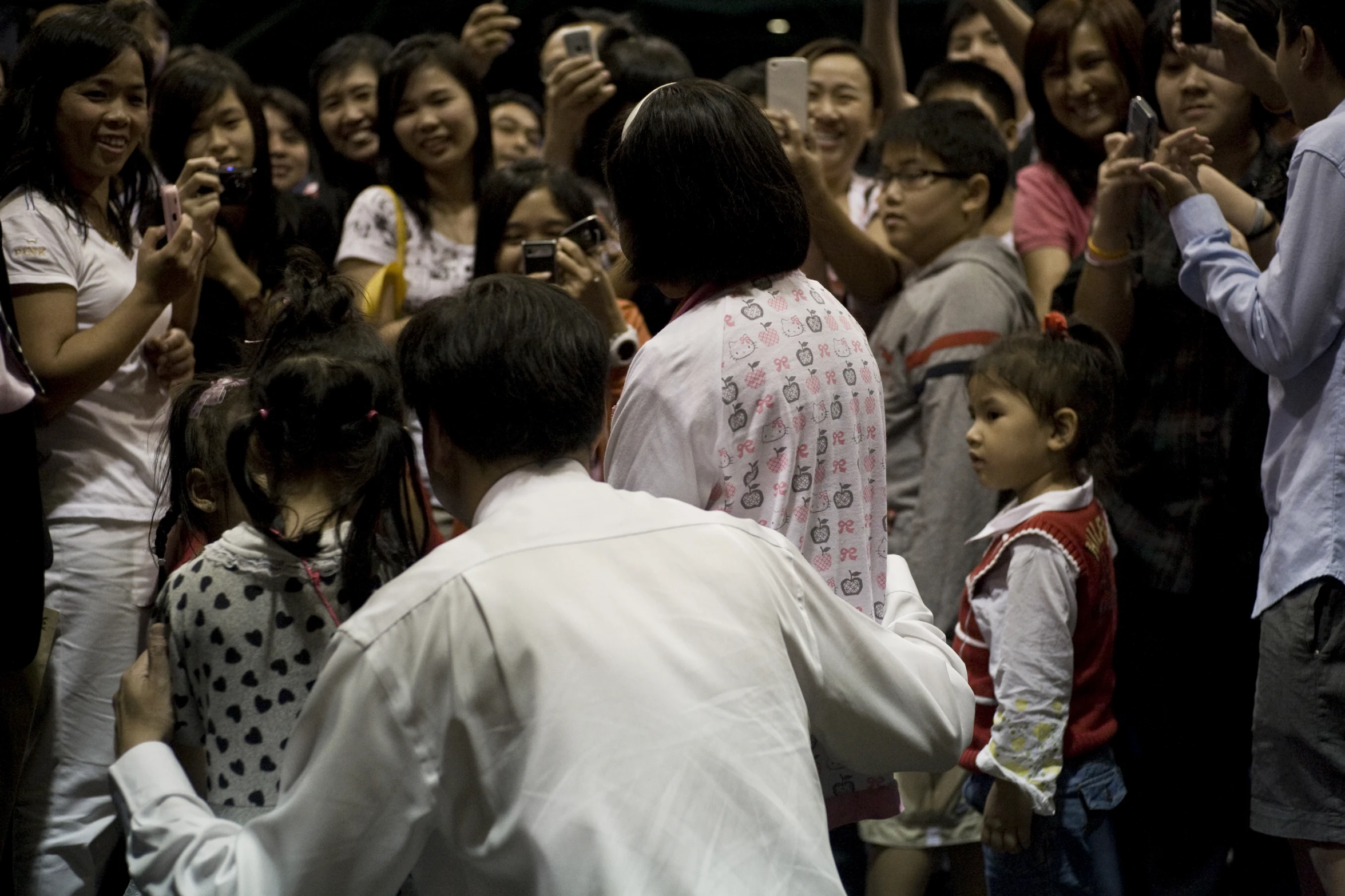 a bunch of people in a group taking pictures