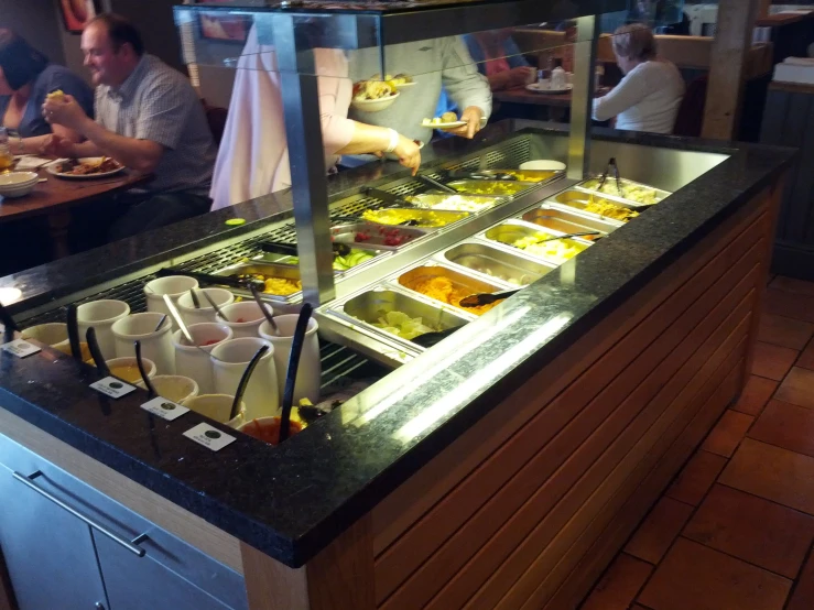 a buffet with people eating out of trays