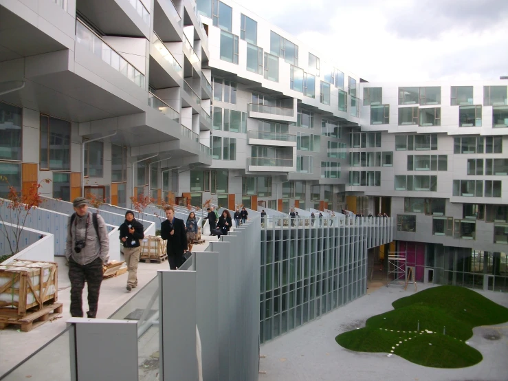 people walking along the balconies of a large building