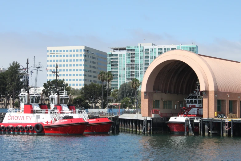 the boats are tied to the dock near the city