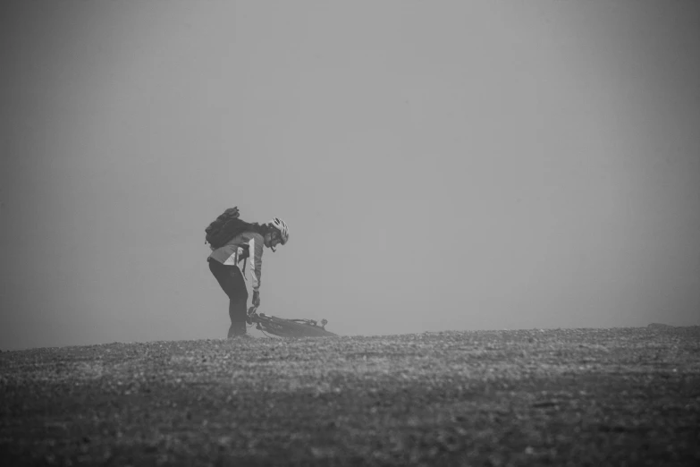 person in the middle of a field with his dog