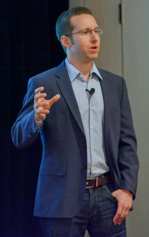 a man that is standing up giving a talk