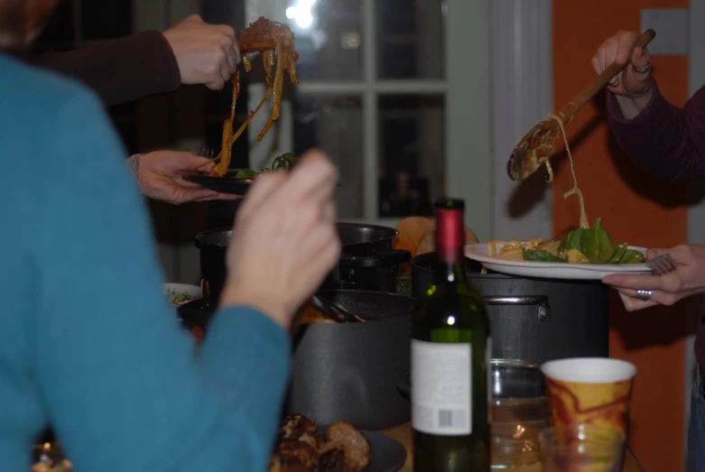 three women eating food with wine and some containers