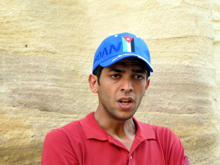 a man with a blue hat making a surprised face