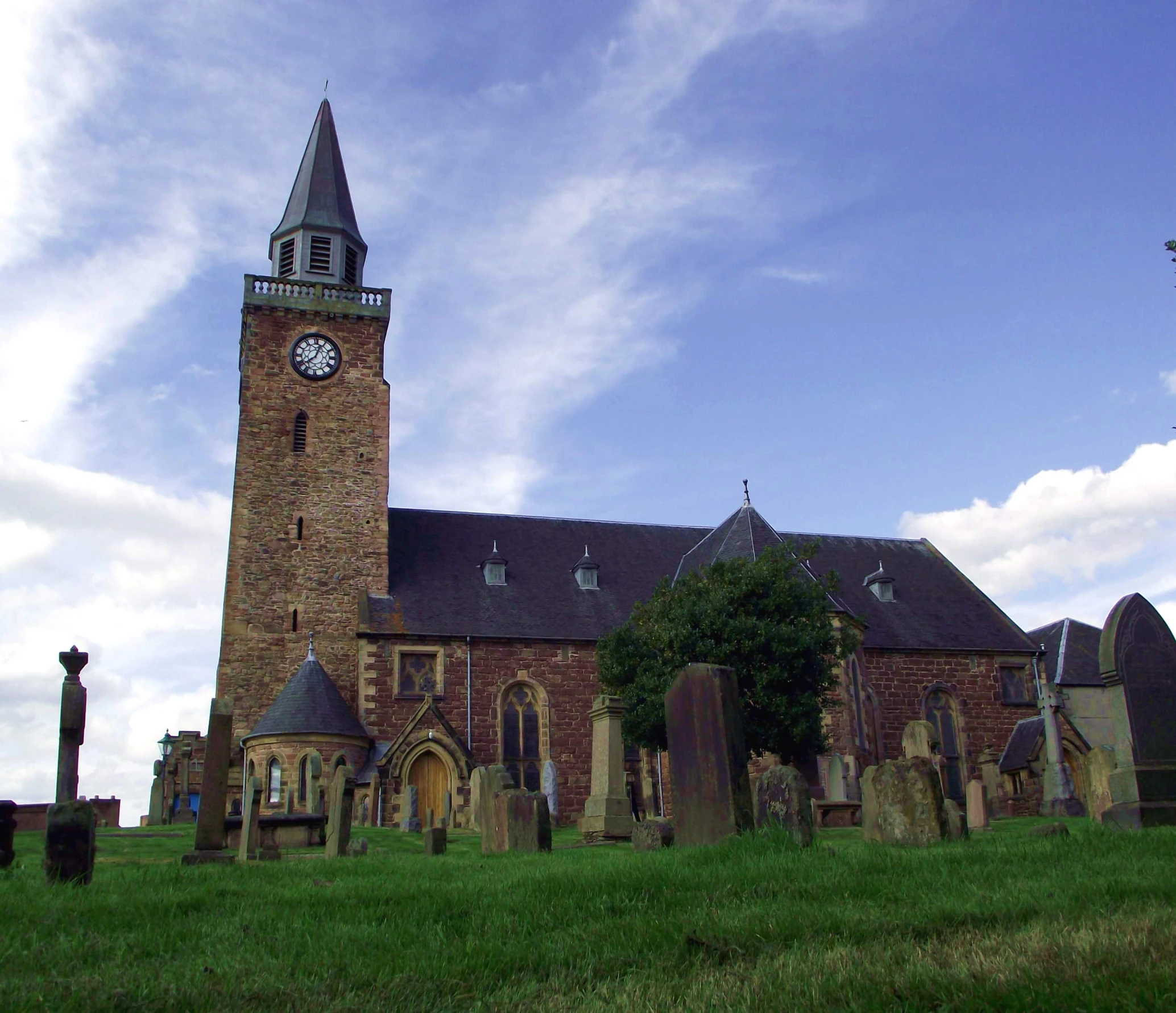 an old church with a steeple and a clock on it