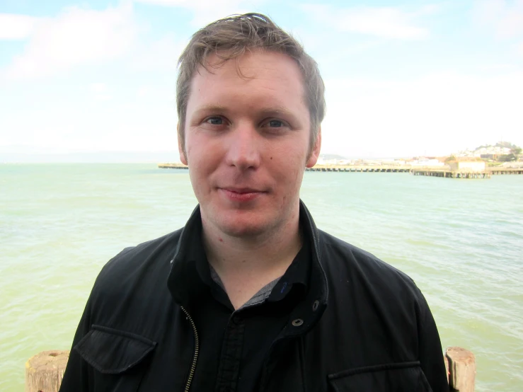 a man who is standing near the ocean