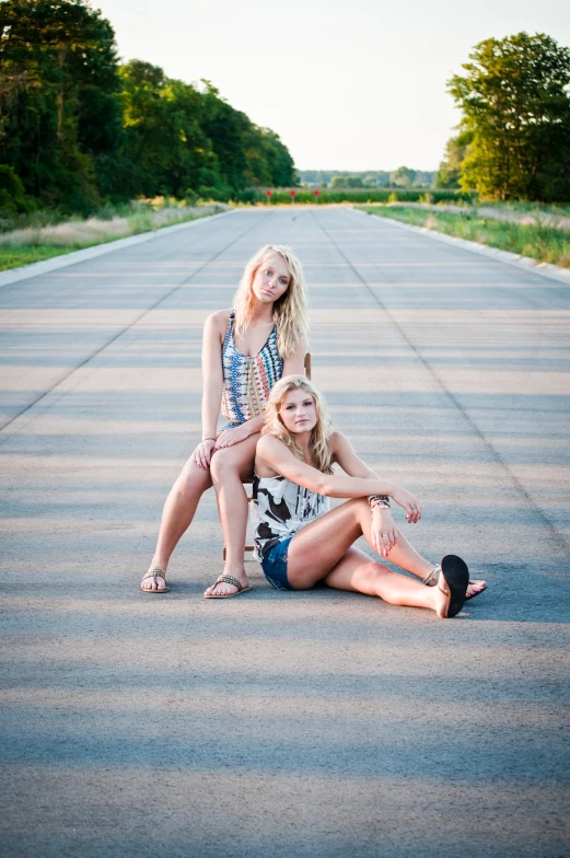 a mom and daughter sitting on the ground