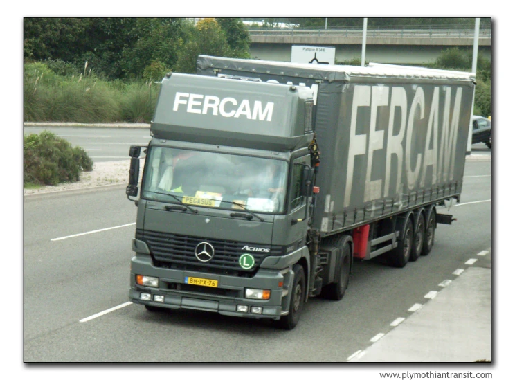 a large truck driving down the road near other vehicles