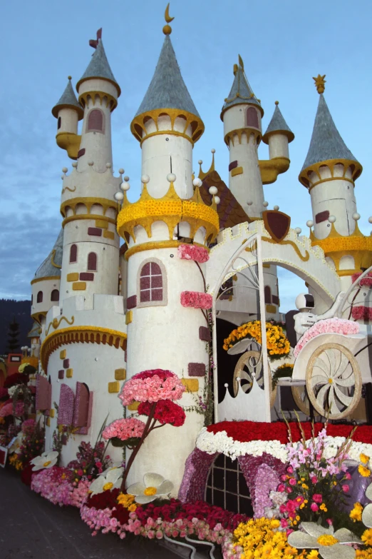 a very elaborate decorated castle with flowers in the foreground