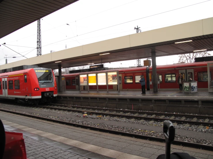 the train is stopped at the platform of the railroad station