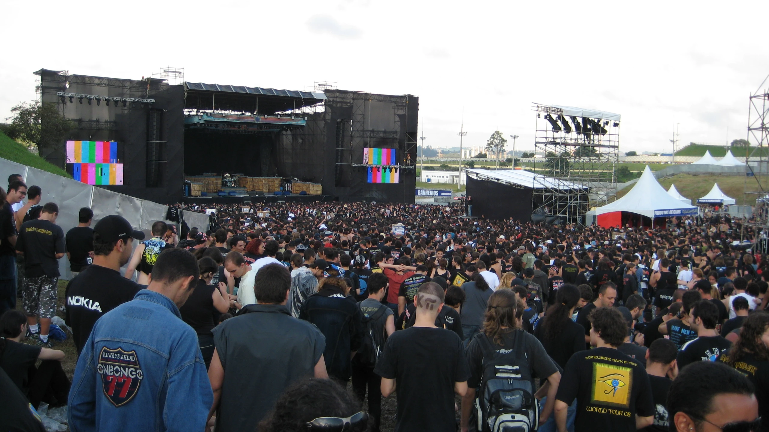 an outside concert has lots of people standing around