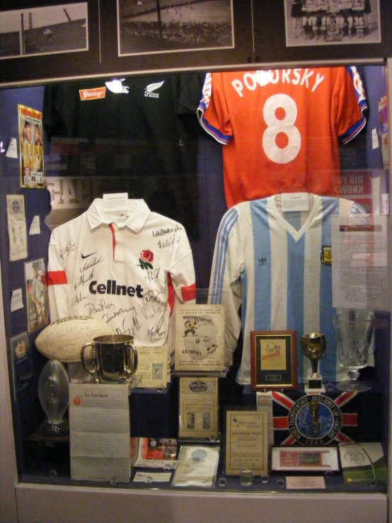 the soccer shirt is in a case on the wall