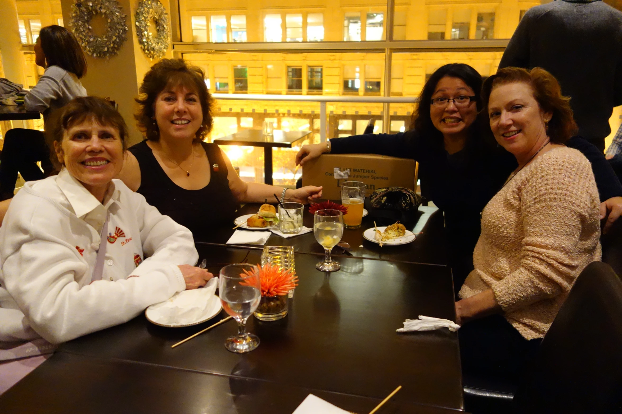 a group of ladies at a table sharing a meal