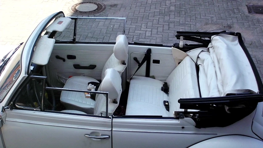 an old car with several seats, luggage and accessories in it