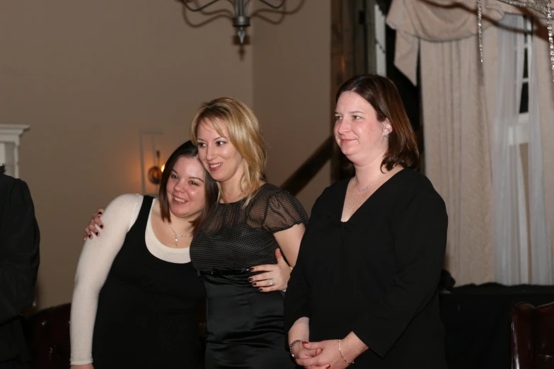 three woman standing together at a party