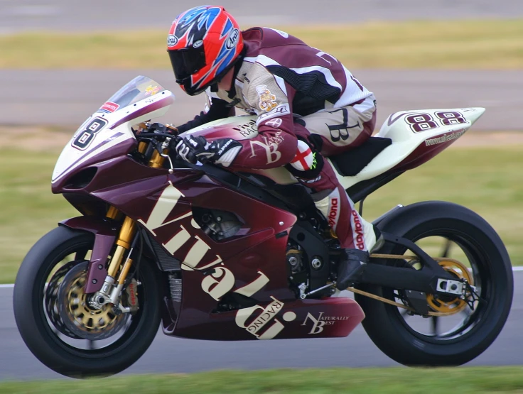 a person on a motorcycle in mid - turn during a race