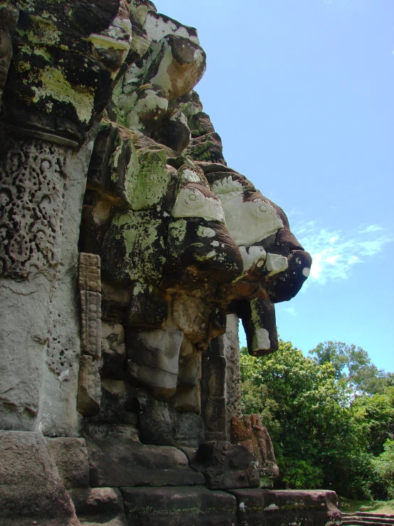 an ancient carved stone sculpture of a person with a big nose