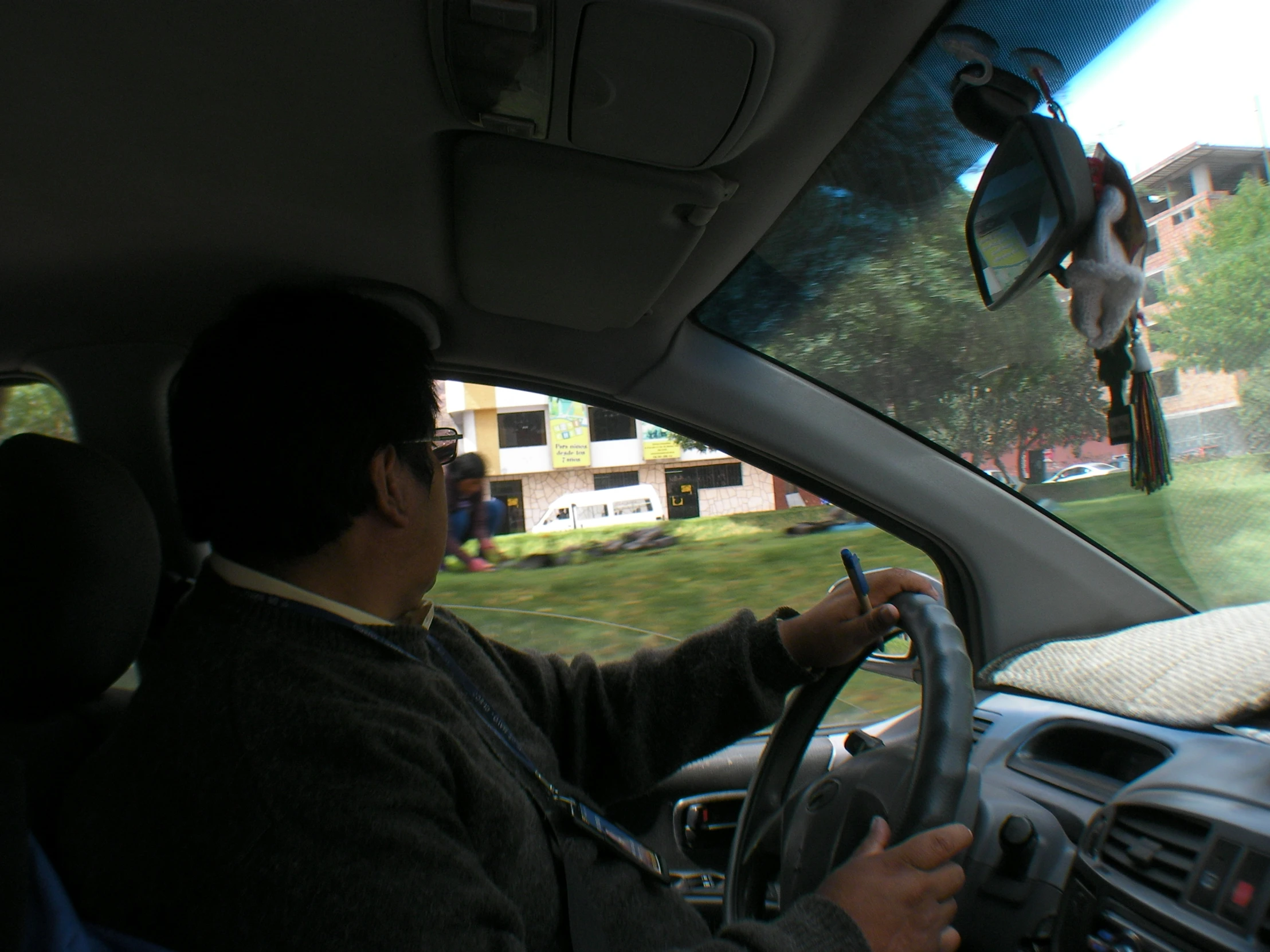 there is a man that is sitting in the car driving