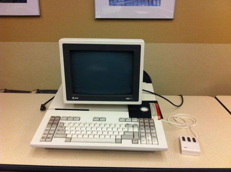 an old computer sitting on top of a desk