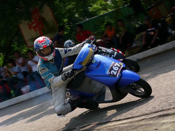 a man on a motorcycle in front of people